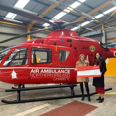 AYMES Partnership Manager handing over cheque to Air Ambulance NI