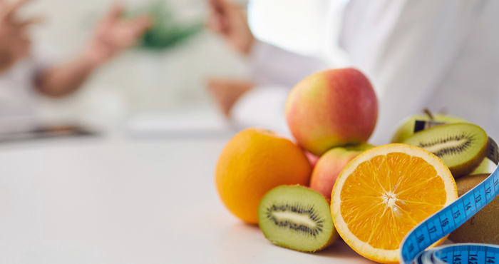 picture of fruit with dietitian in the background