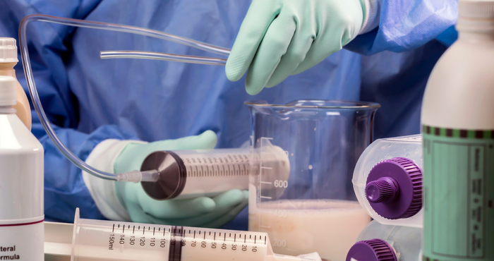 Healthcare professional setting up enteral feeding