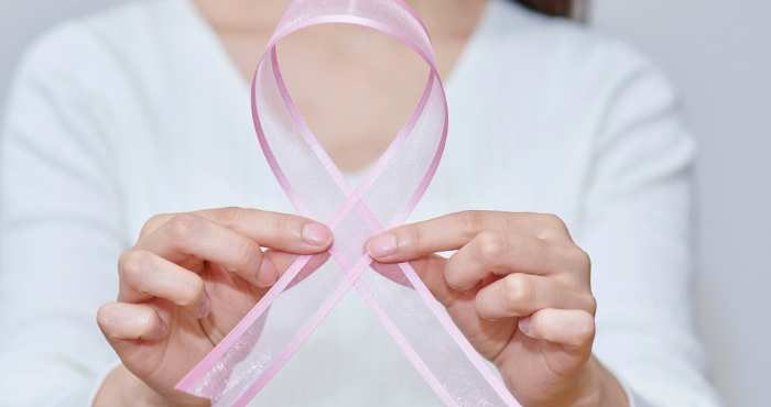 woman holding a pink ribbon