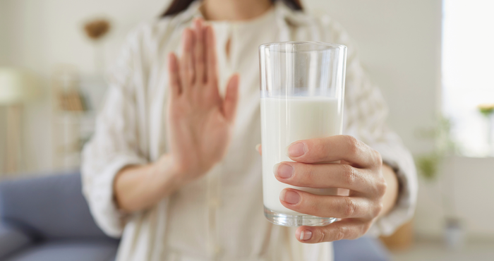 lady refusing a glass of milk