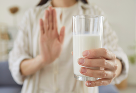 lady refusing a glass of milk
