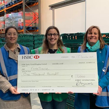 AYMES partnership manager handing over cheque