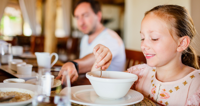young girl eating fortified soup