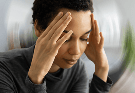 Lady holding the temples on her head