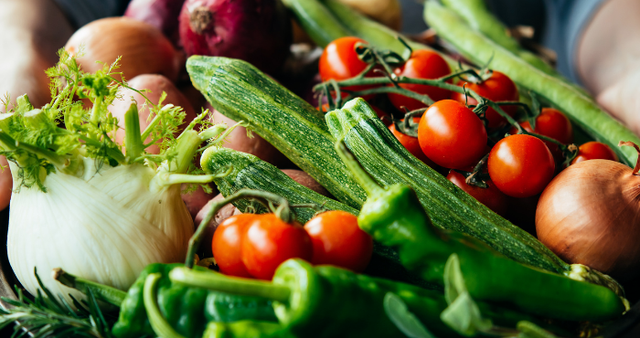 lady holding basket of fresh vegetables