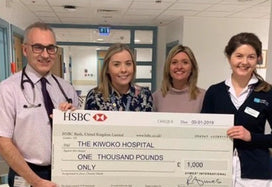 AYMES presenting cheque to Friends of Kiwoko Hospital