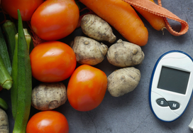 vegetables sitting with diabetes monitor