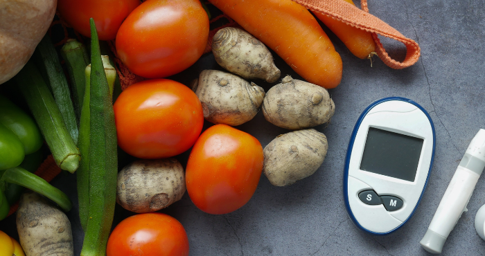 vegetables sitting with diabetes monitor