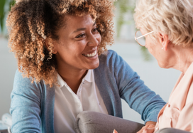 carer smiling with elderly patient