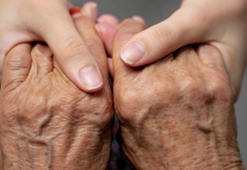 carer holding hands with a patient