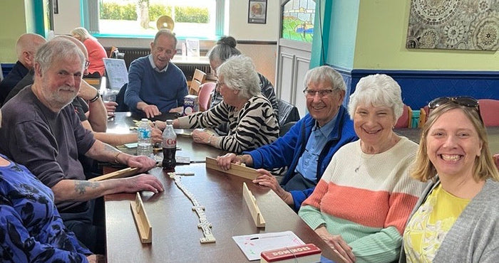 Sam playing dominoes at the AGE UK's event