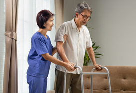 Carer helping man with sarcopenia