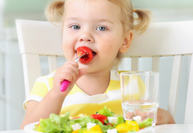 toddler eating a strawberry