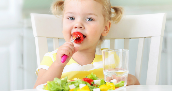 toddler eating a strawberry