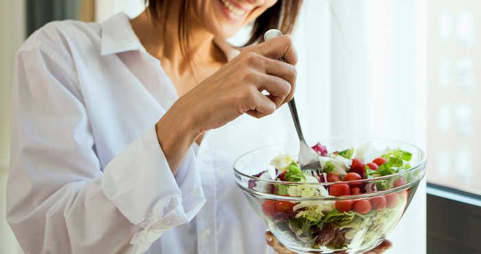 lady going through menopause eating salad