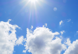 the beaming sun shining through clouds