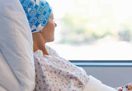 cancer patient in bed looking out of the window