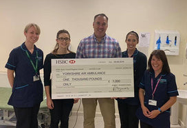 Yorkshire Air Ambulance receiving cheque from AYMES