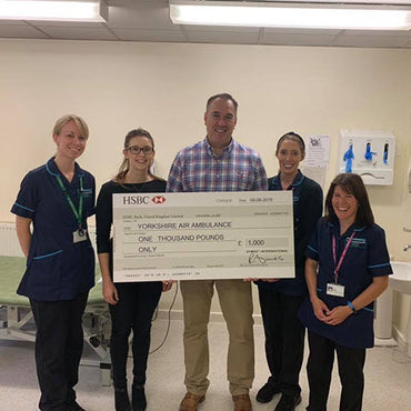 Yorkshire Air Ambulance receiving cheque from AYMES