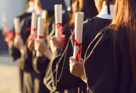 graduates holding their certificates