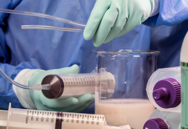 Healthcare professional setting up enteral feeding