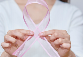 woman holding a pink ribbon
