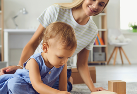 teenager and toddler playing
