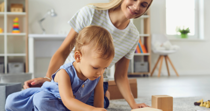 teenager and toddler playing