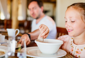 young girl eating fortified soup