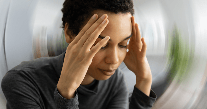 Lady holding the temples on her head
