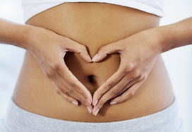 lady making heart shape with hands over her stomach