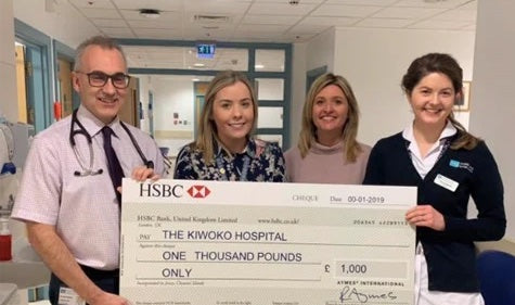 AYMES presenting cheque to Friends of Kiwoko Hospital