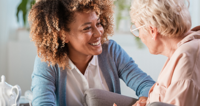 carer smiling with elderly patient