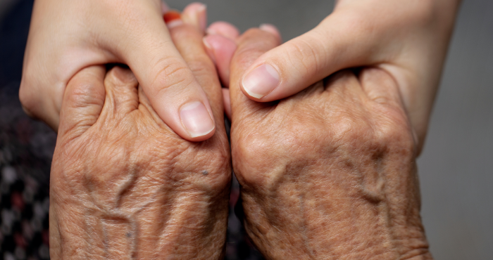 carer holding hands with a patient