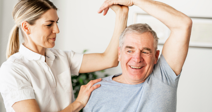 Healthcare professional doing excercises with man