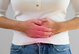 lady with bowel cancer holding her tummy