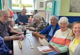 Sam playing dominoes at the AGE UK's event