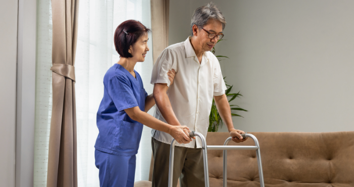 Carer helping man with sarcopenia