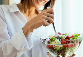 lady going through menopause eating salad