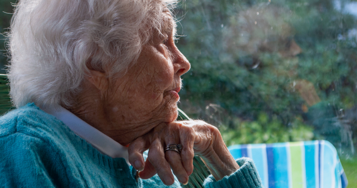 malnourished lady sitting at window