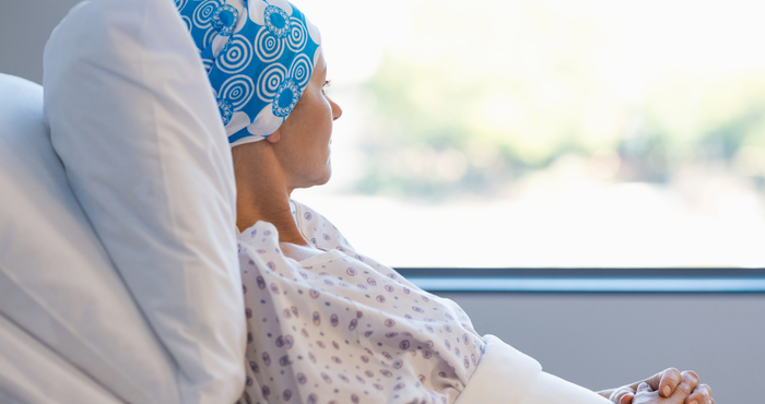 cancer patient in bed looking out of the window